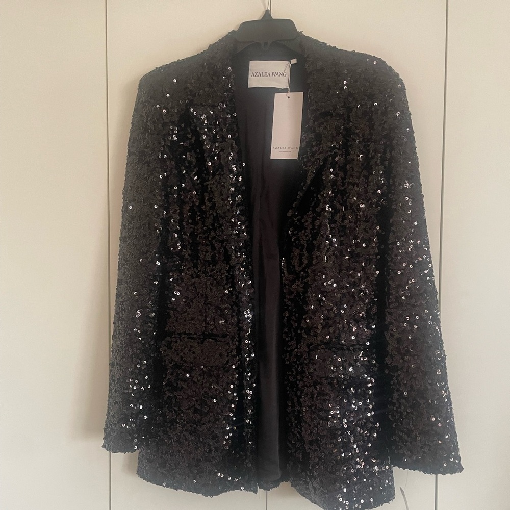 NWT sequin jacket with one button closure.